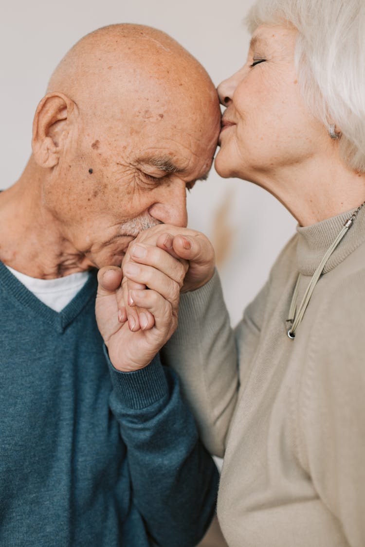 Man Kissing A Woman On Hand