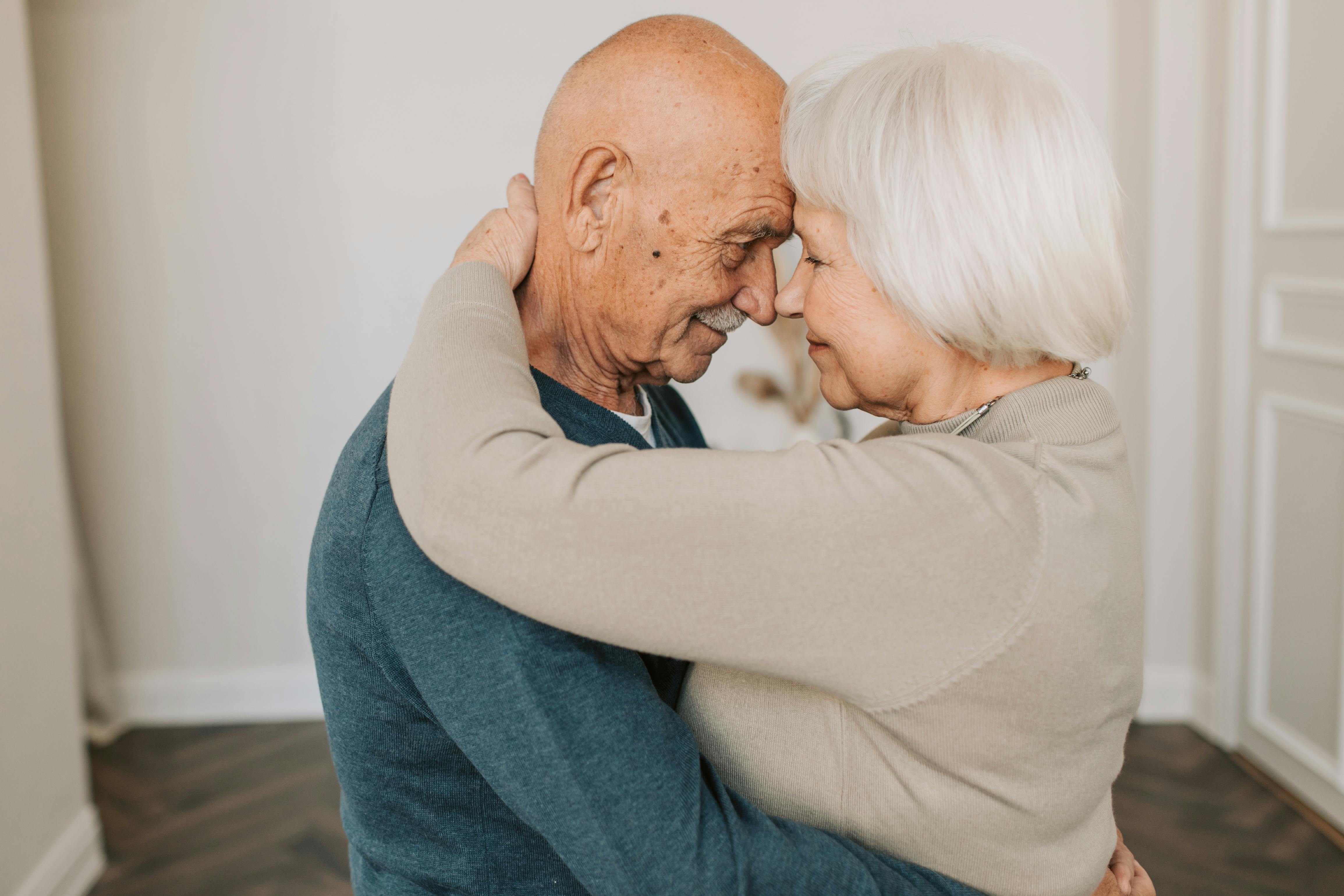 elderly couple hugging each other