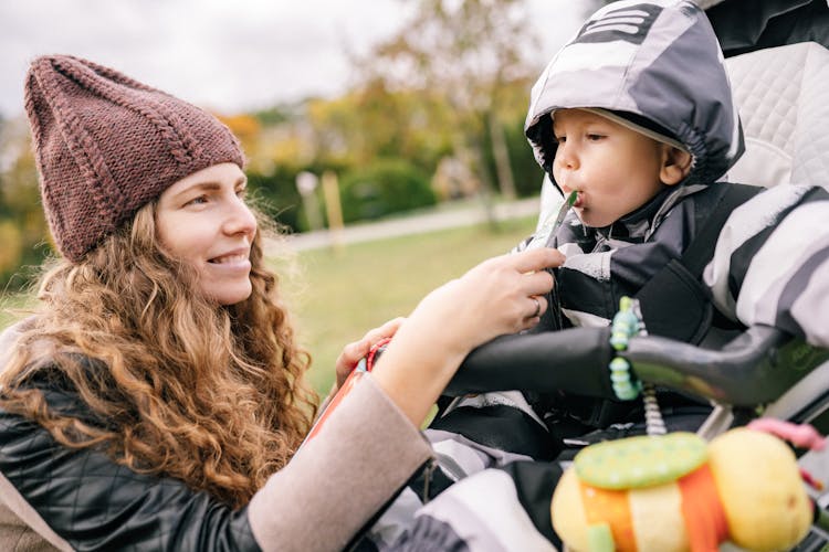 Mother Feeding Child In Pram