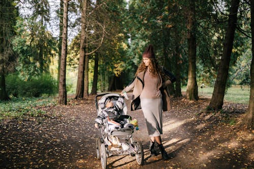 Free Woman with Her Baby in the Stroller Stock Photo