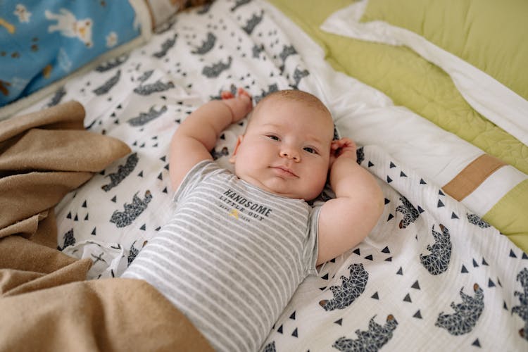 Baby In White And Gray Stripe Onesie