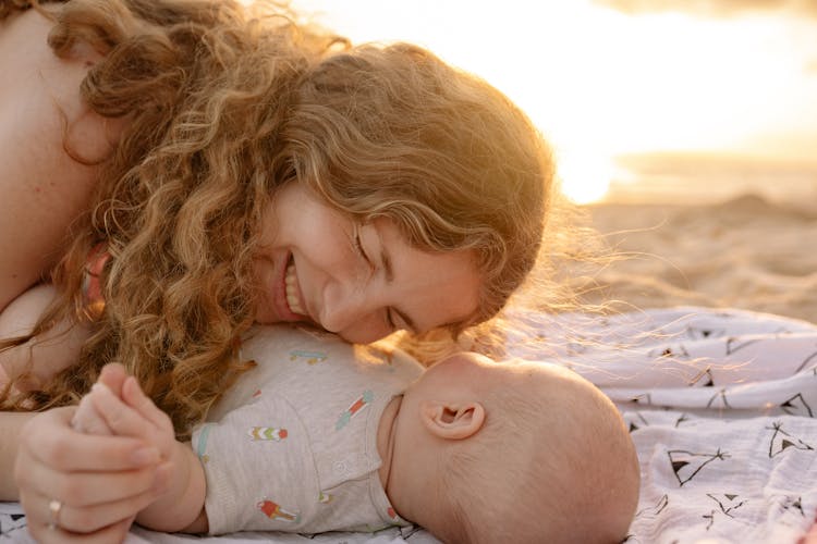 Woman Smiling At Baby In Gray Onesie