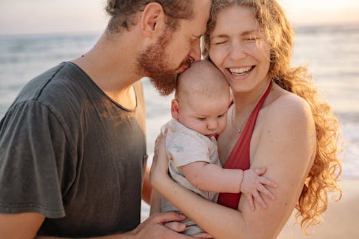 A cheerful family moment with parents and baby by the seaside, embracing love and connection.