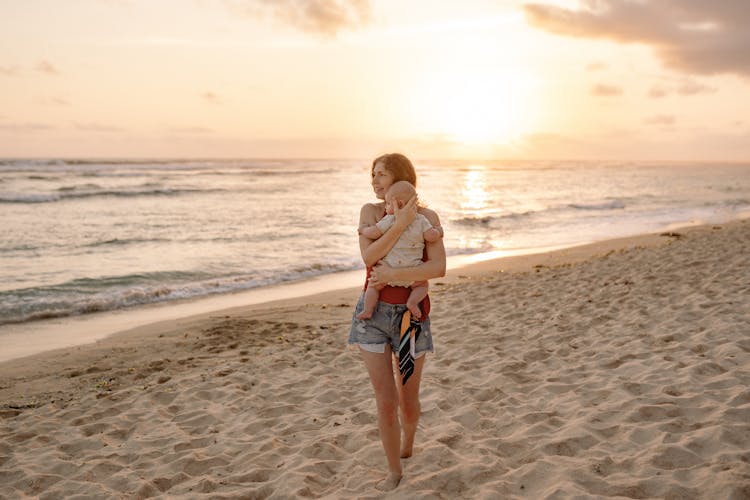 A Woman Carrying Her Baby