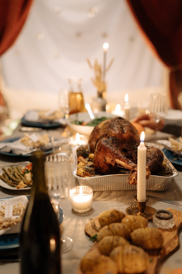 Cooked Meat On Silver Tray Near Lighted Candle