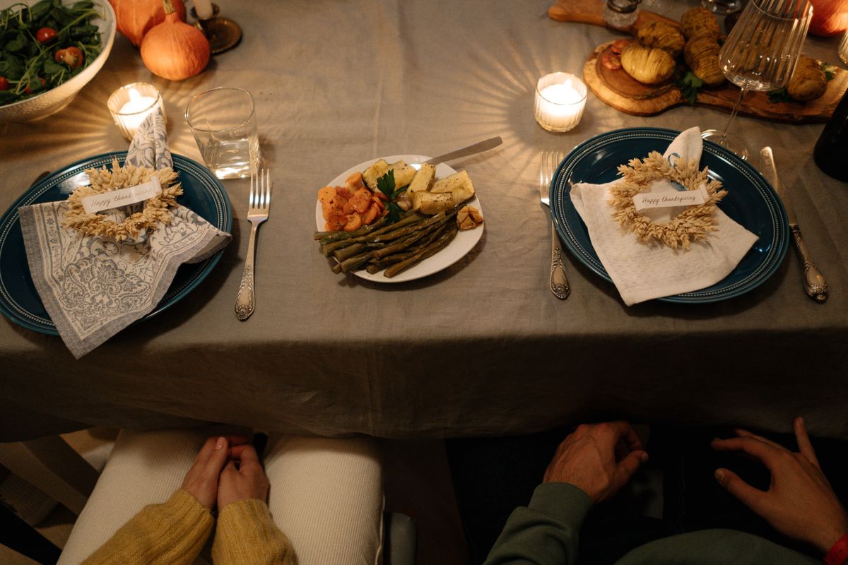 Elegant Thanksgiving dinner setting with candles and plates