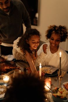 A warm family dinner with candles and togetherness. Perfect for holiday celebrations and gatherings.