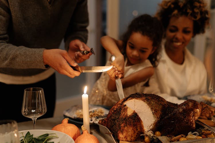 Little Girl Slicing The Turkey