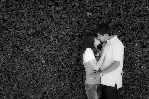 Man and Woman Kissing on Grayscale Photography