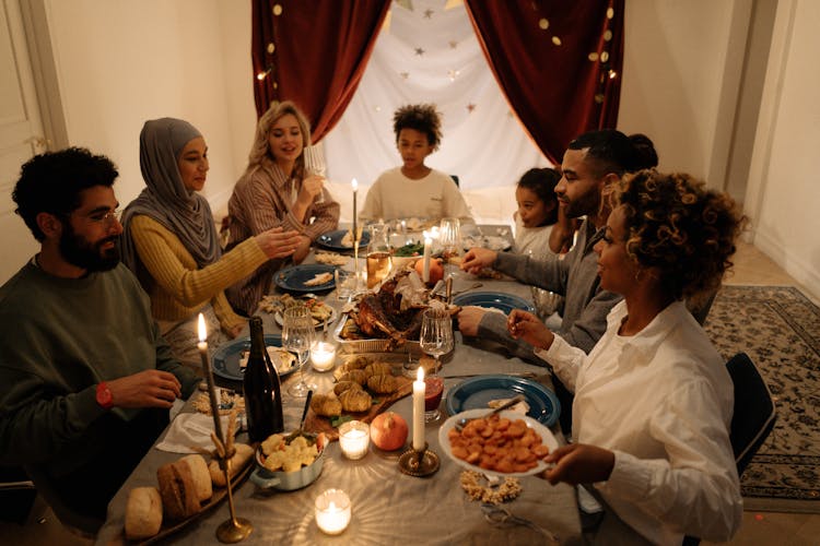 A Happy Family Talking While Having Dinner