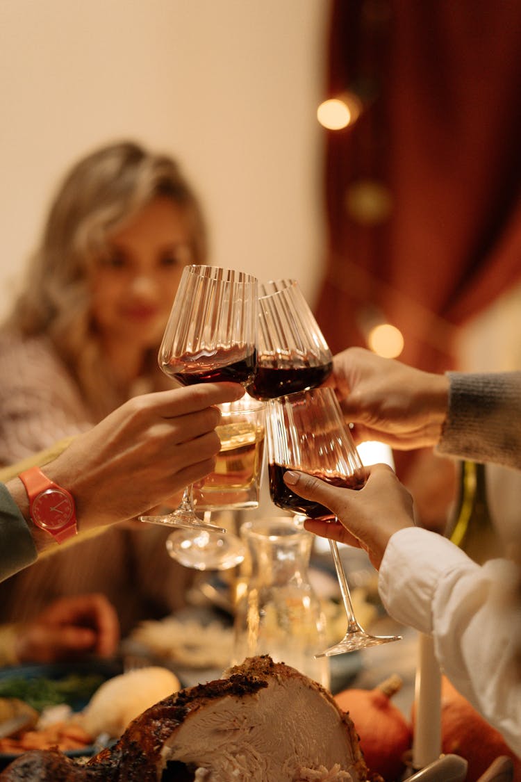 A Group Of People Toasting Drinks