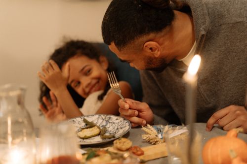 Free Joyful family dinner with candlelights and smiles, capturing warmth and togetherness. Stock Photo
