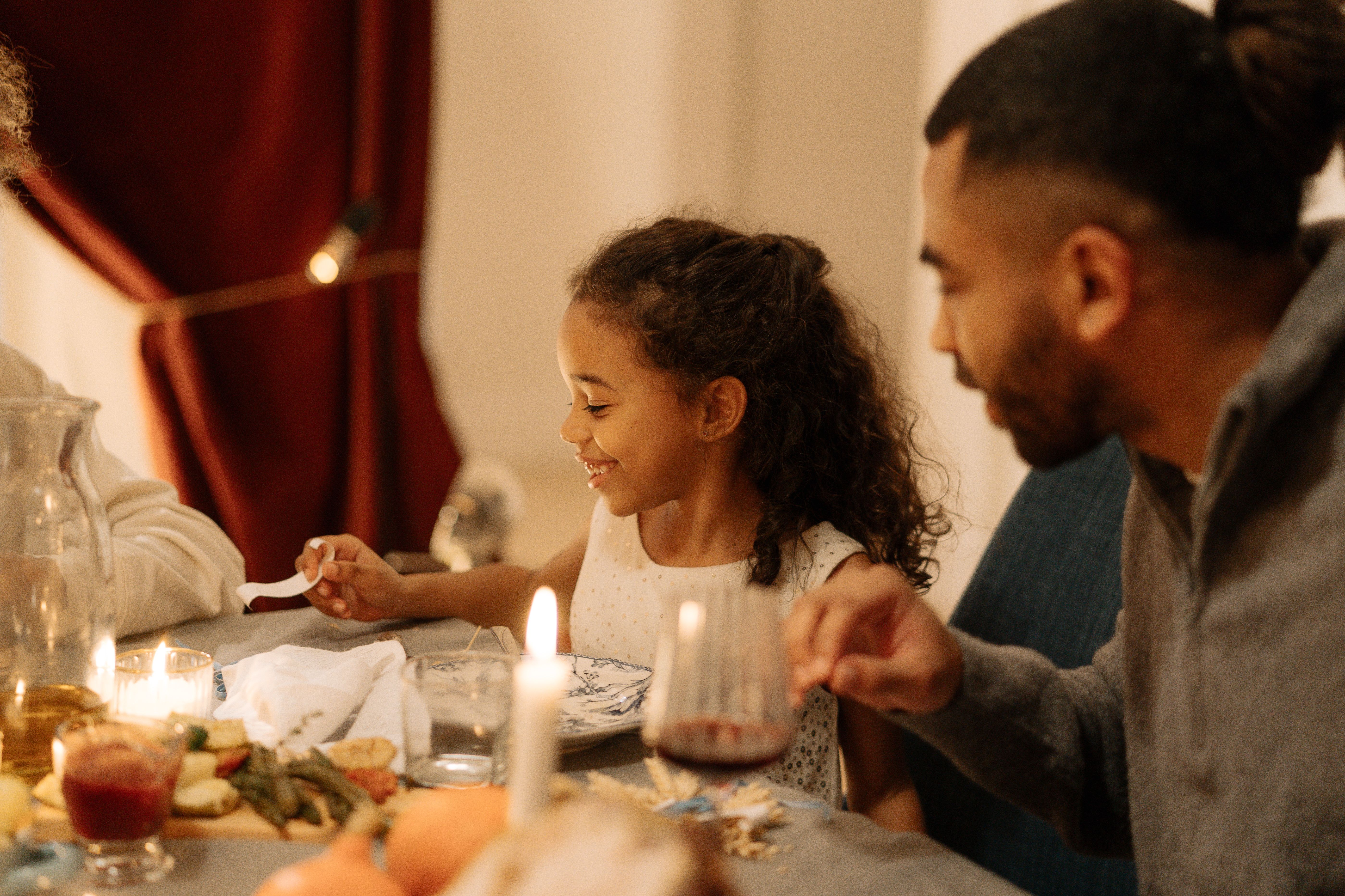 A father and daughter having dinner