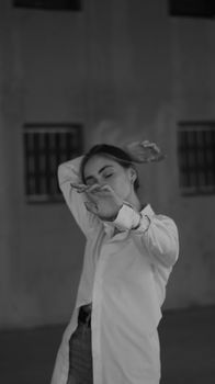 Stylish black and white portrait of a woman posing with elegance in a long sleeve shirt.