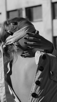 A black and white portrait of a woman with a blindfold, creating a mysterious and dramatic mood.