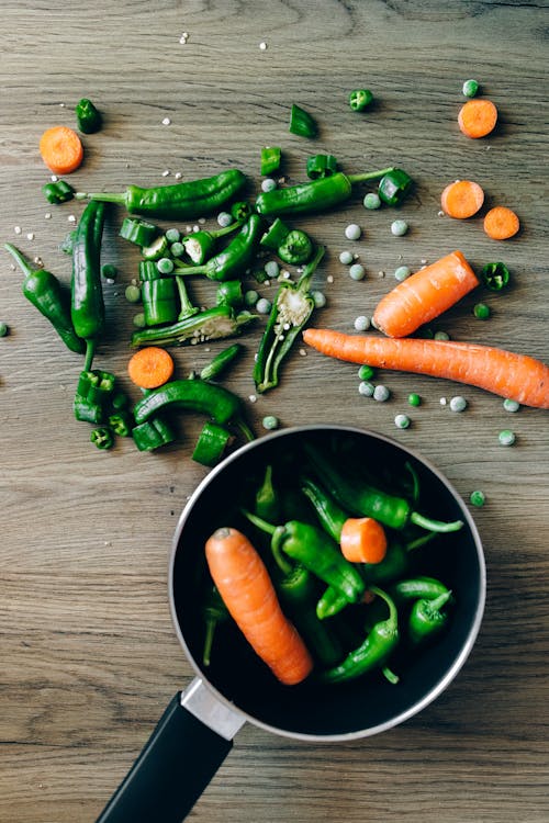 Slices of Fresh Vegetables on Wooden Surface