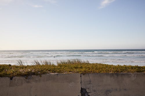 Cement fence near rippling sea