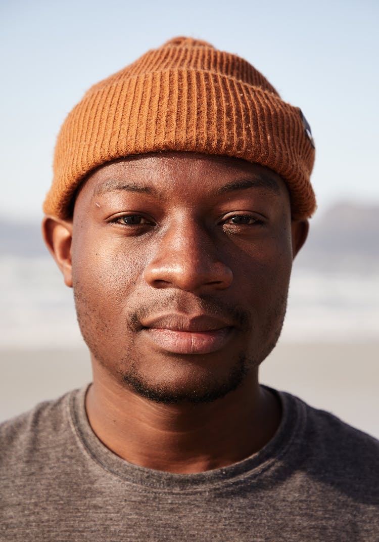 Calm Masculine Black Man In Knitted Hat