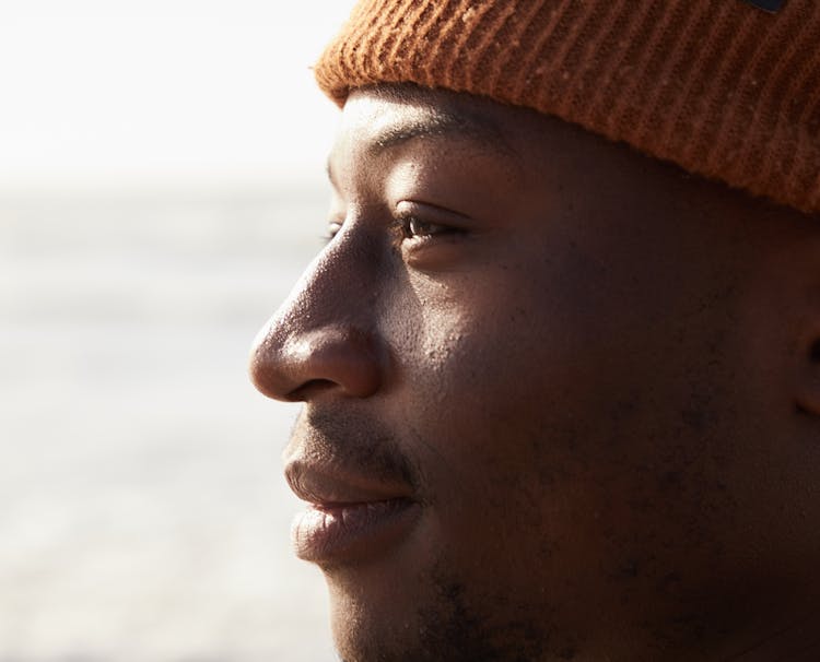 Crop Contemplative Young Ethnic Man In Sunlight