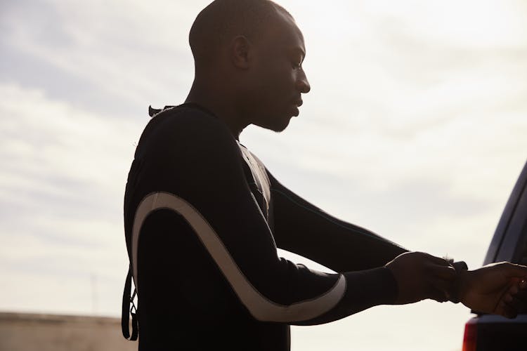 Crop Black Athlete Putting On Diving Suit