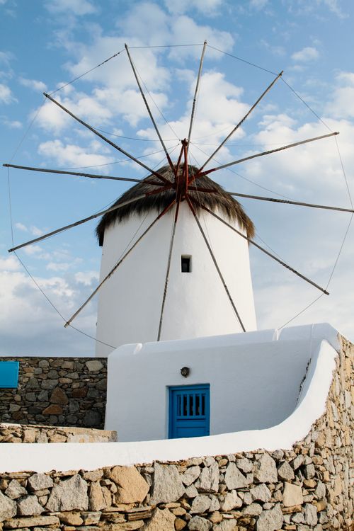 Free Iconic windmill against a bright sky in Mykonos, representing Greek architecture and culture. Stock Photo