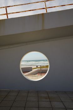 当代海滨建筑采用可欣赏海景的圆形窗户，非常契合宁静与现代的设计理念
