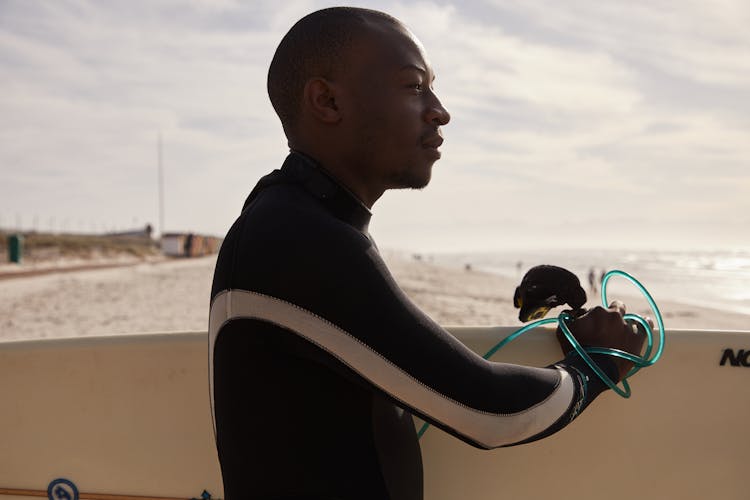 Serious Black Man Preparing For Surfing In Ocean