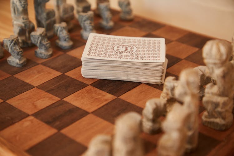 Chessboard With Chess Pieces And Game Of Cards