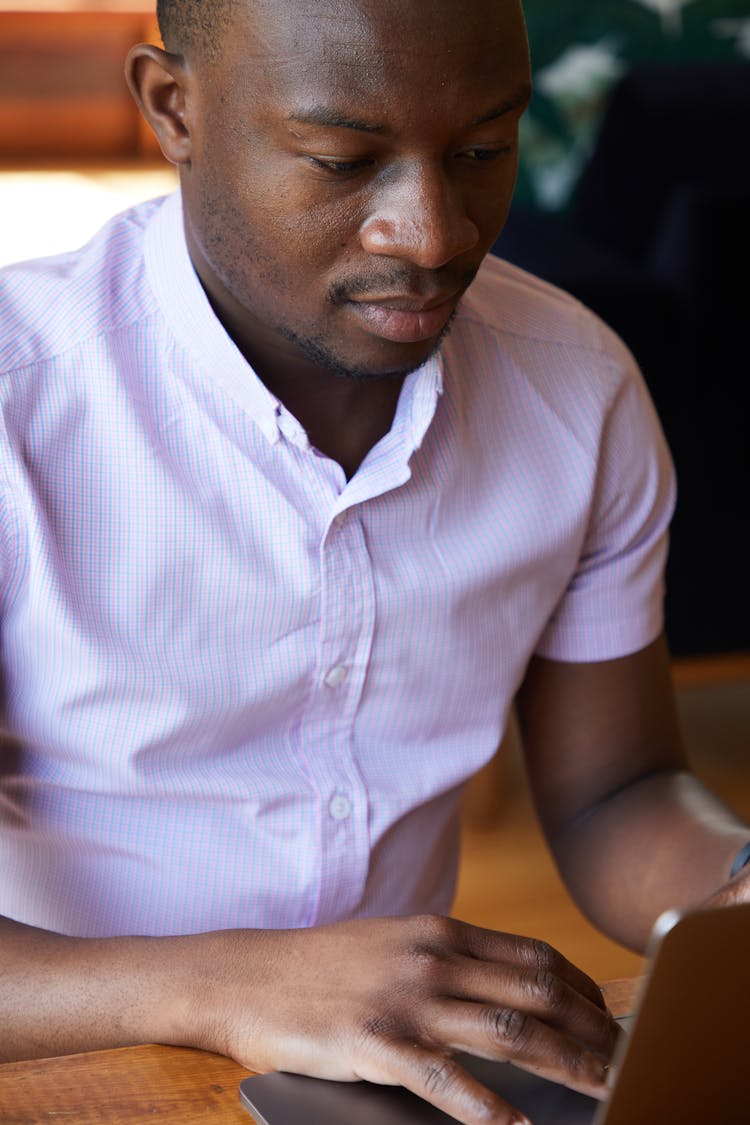 Black Man Checking News On Laptop