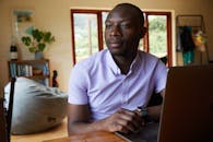 Black entrepreneur with smart watch and laptop