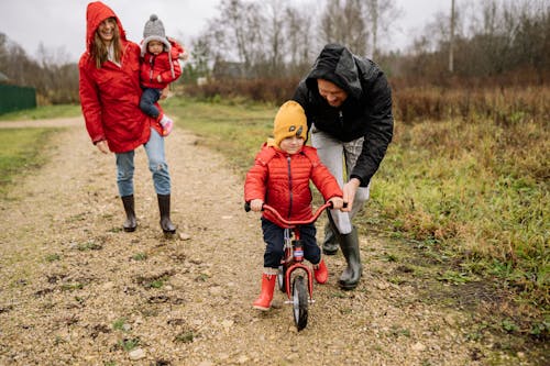 Man Teaching His Child How to Ride a Bicycle