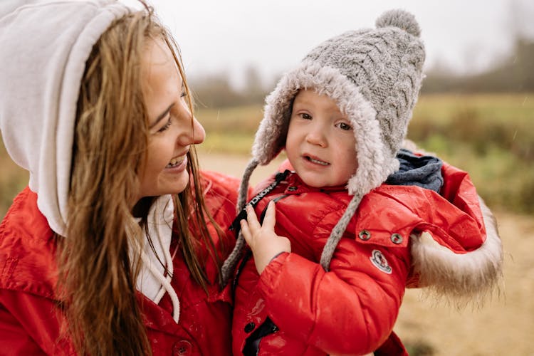 A Mother And Child Wearing Red Jackets