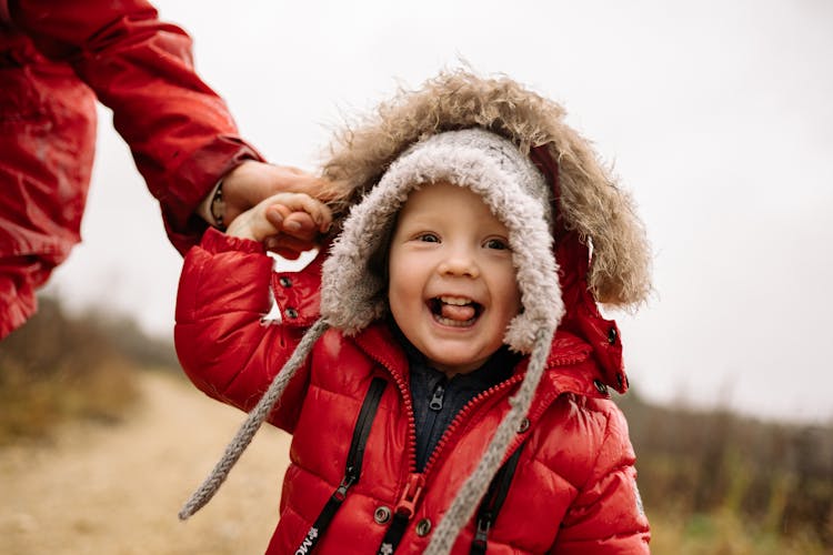 A Cute Baby In Red Puffer Jacket