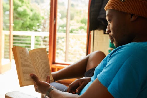Free African American man reading book at home Stock Photo