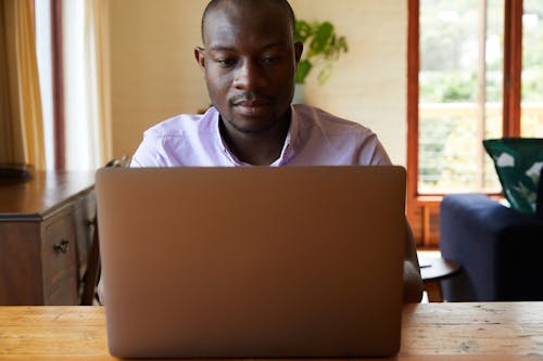Serious African American man with laptop