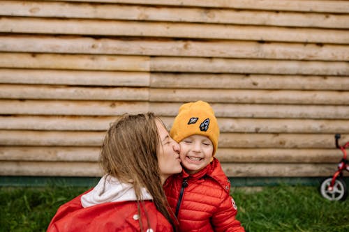 Mother Kissing Her Cute Child