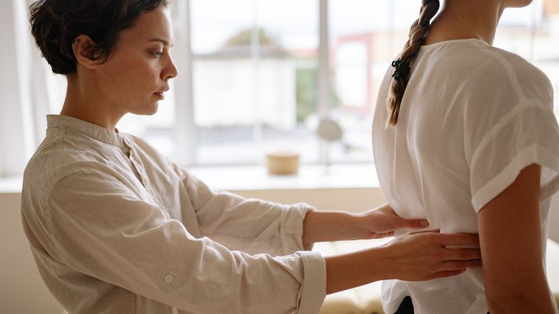 CBD topical applied to back for scoliosis pain and muscle spasm