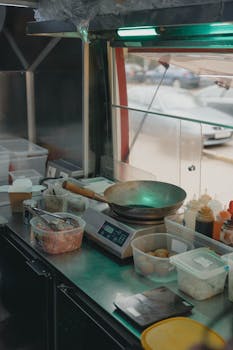A glimpse into a food truck kitchen with various cooking tools and ingredients.