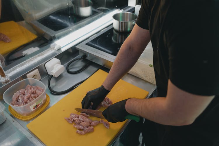 A Person Slicing Meat