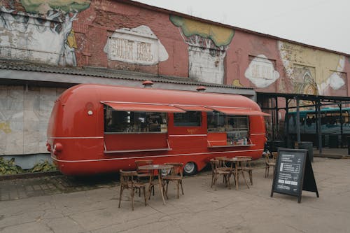 A Red Food Truck on a Brick Pavement