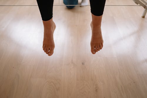 Bare Feet Over the Wooden Floor