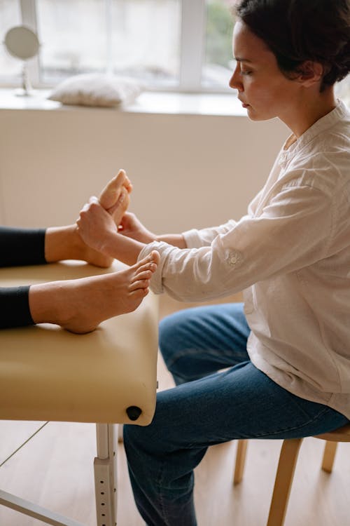 A Therapist Giving Her Client a Foot Massage