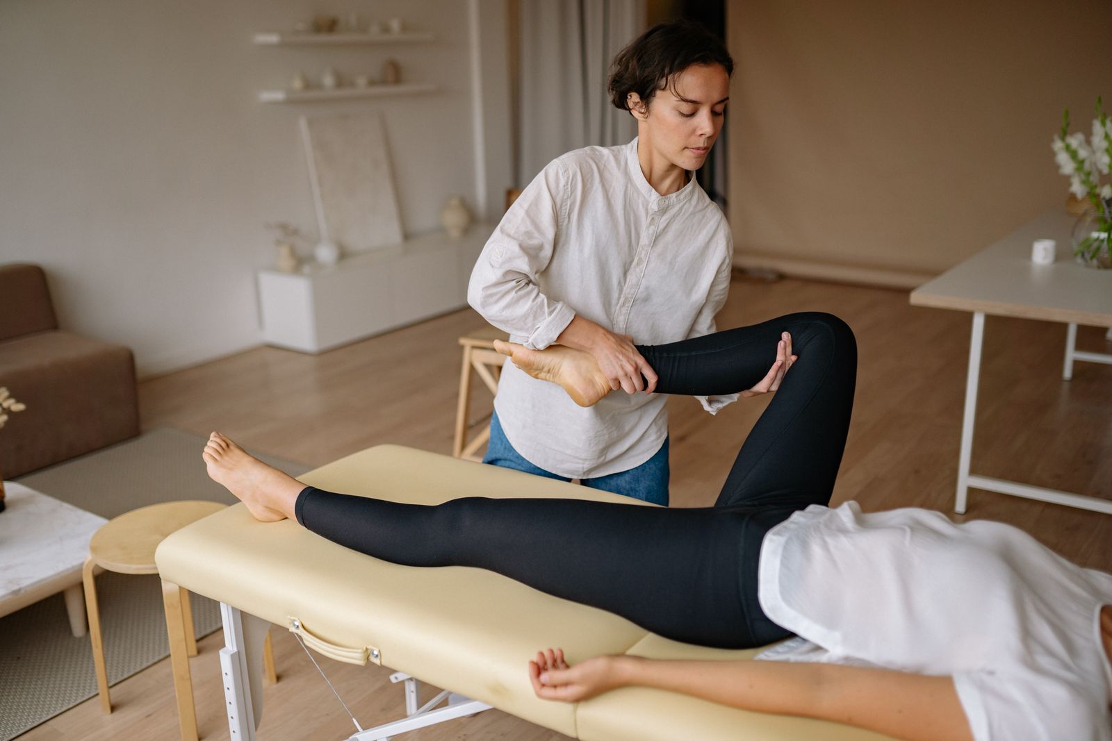 Person seated outdoors adjusting a knee support before activity
