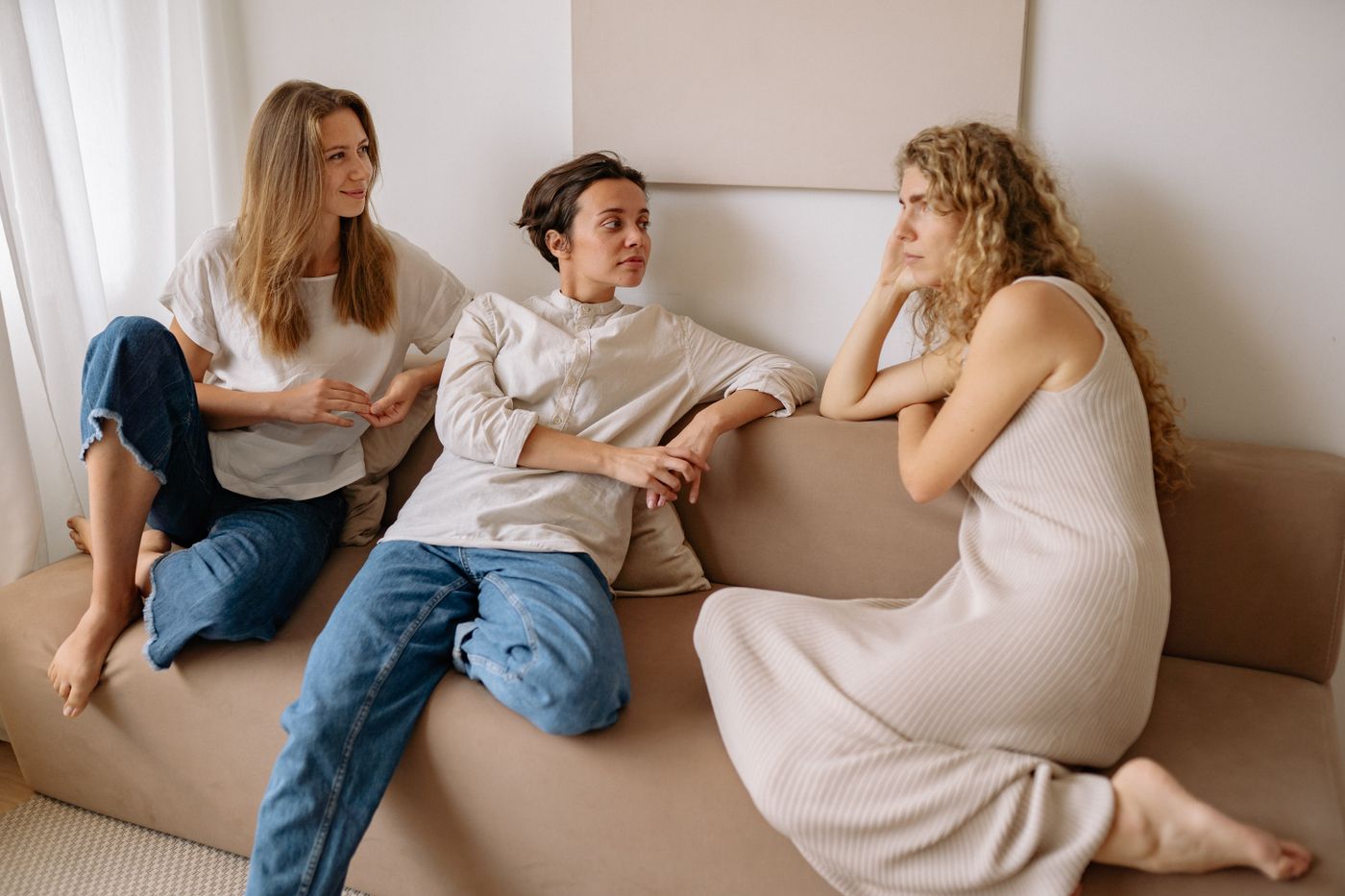 Three people in conversation on a sofa — photo by Yan Krukau on Pexels