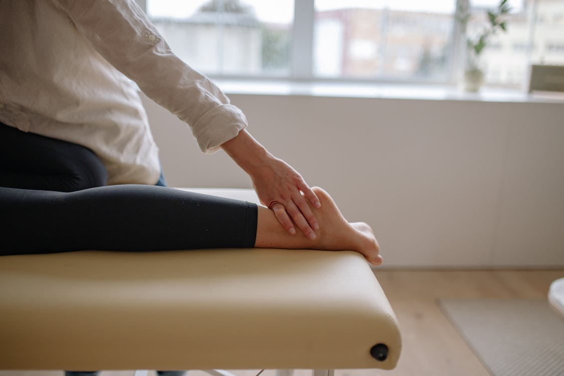 A Person Lying Down and Getting a Massage 