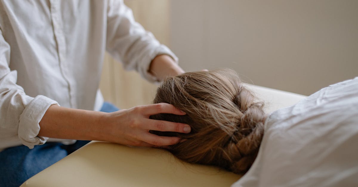 A person receiving a head massage in a spa setting.
