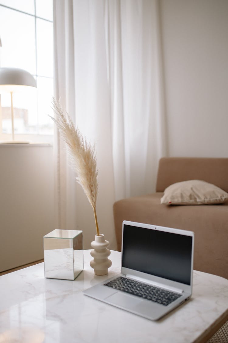 A Laptop On A Marble Table Top