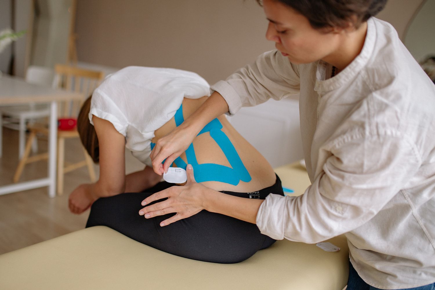 Therapist treating a patient's back injury during a rehabilitation session