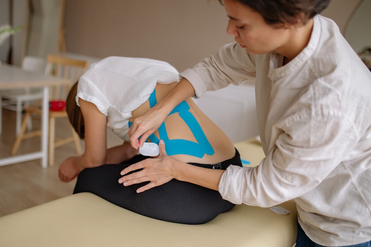 Woman receiving supportive back care in a clinical setting