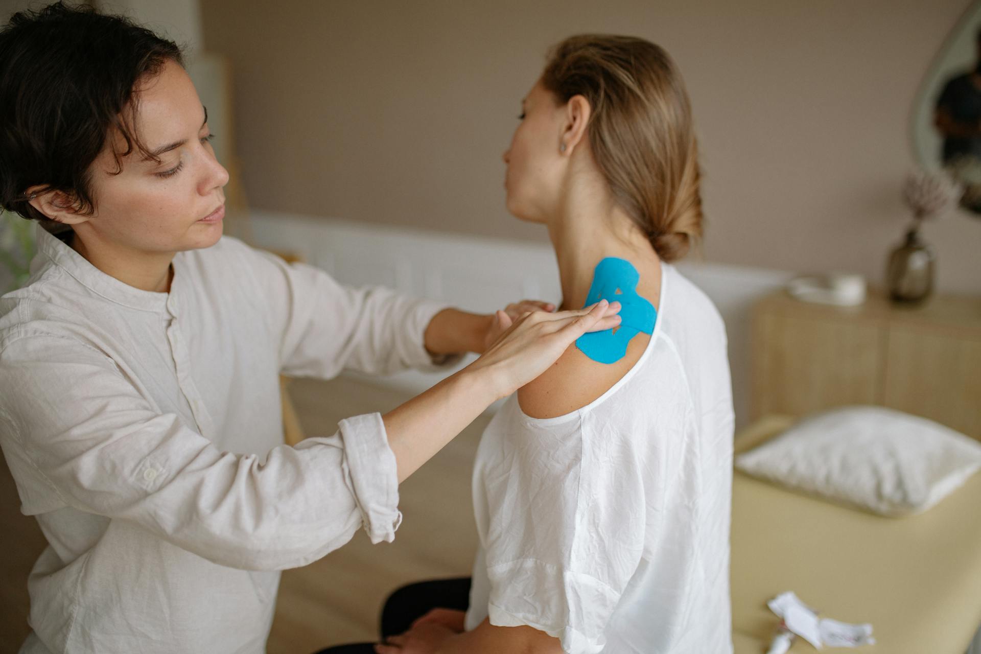 Woman Taping Client Back